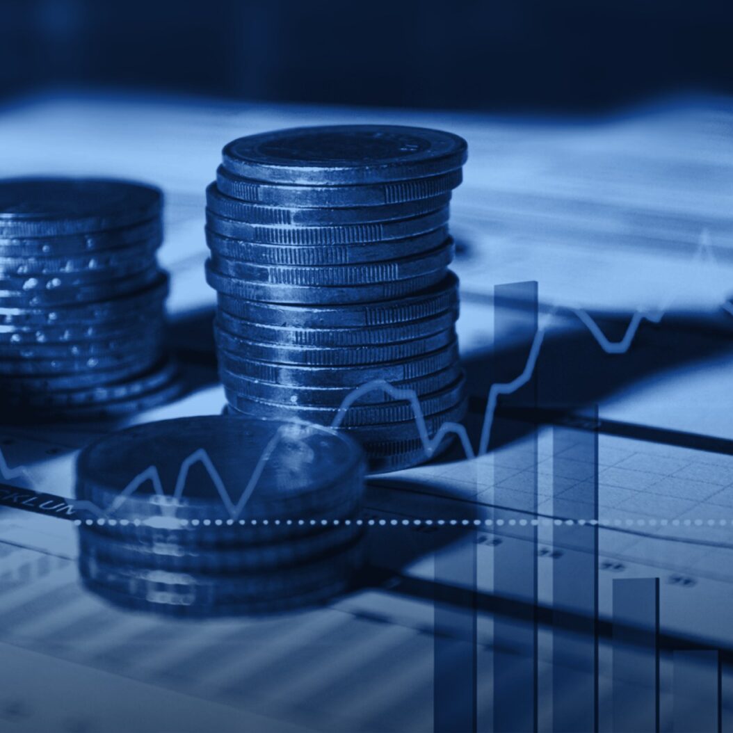 Stacks of coins on financial charts